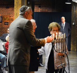Alan and Halina Zimm lighting a candle