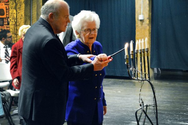 Simone Schwarz lighting a candle